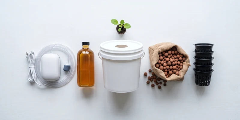 Beginner hydroponic starter kit laid out with bucket, net pots and nutrients